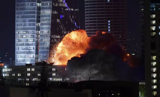 An explosion is seen during a missile attack in Tel Aviv, Israel, Friday, June 13, 2025. (AP Photo/Tomer Neuberg)