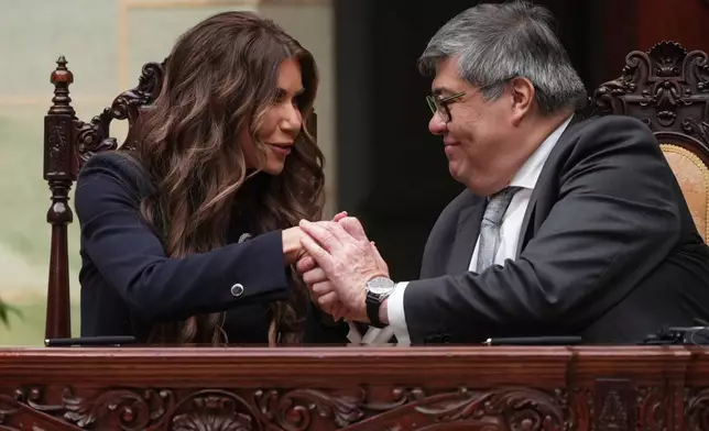 U.S. Homeland Security Secretary Kristi Noem, left, shakes hands with Guatemalan Interior Minister Francisco Jimenez, at a signing ceremony at the National Palace in Guatemala City, Thursday, June 26, 2025. (AP Photo/Moises Castillo)