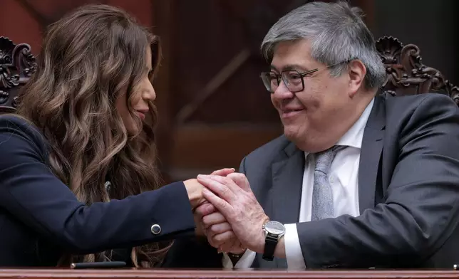 U.S. Homeland Security Secretary Kristi Noem and Guatemalan Minister of Governance Francisco Jimenez shake hands after signing an understanding on a joint security program agreement, at the Palacio Nacional de la Cultura, in Guatemala City, Thursday, June 26, 2025. (Anna Moneymaker/Pool Photo via AP)
