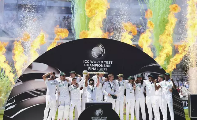 South African players celebrate with the winner's trophy after their win in the World Test Championship final against Australia at Lord's cricket ground in London, Saturday, June 14, 2025. (AP Photo/Kirsty Wigglesworth)