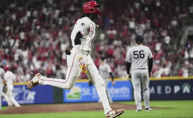 Cincinnati Reds' Elly De La Cruz celebrates as he runs toward home plate to score the winning run after a single from Gavin Lux during the eleventh inning of a baseball game against the New York Yankees, Tuesday, June 24, 2025, in Cincinnati. (AP Photo/Joshua A. Bickel)