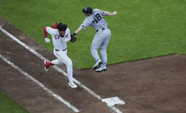 New York Yankees first baseman Paul Goldschmidt, right, tags out Cincinnati Reds' Rece Hinds, left, as he runs toward first during the fourth inning of a baseball game, Tuesday, June 24, 2025, in Cincinnati. (AP Photo/Joshua A. Bickel)
