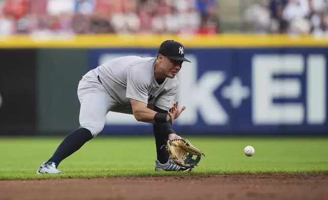 New York Yankees shortstop Anthony Volpe fields a ball hit by Cincinnati Reds' Jose Trevino during the second inning of a baseball game, Tuesday, June 24, 2025, in Cincinnati. (AP Photo/Joshua A. Bickel)