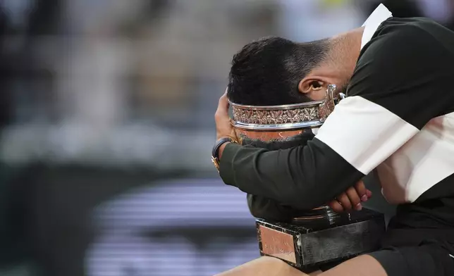Spain's Carlos Alcaraz celebrates with the trophy after winning the final match of the French Tennis Open against Italy's Jannik Sinner at the Roland-Garros stadium in Paris, Sunday, June 8, 2025. (AP Photo/Lindsey Wasson)