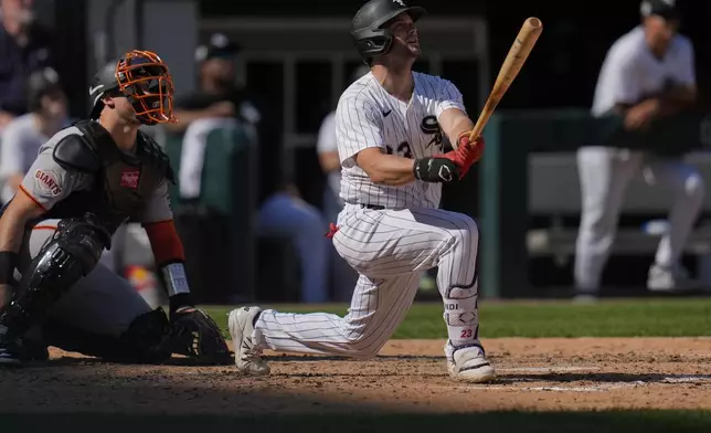Chicago White Sox's Andrew Benintendi (23) hits a solo home run during the sixth inning of a baseball game against the San Francisco Giants, Saturday, June 28, 2025, in Chicago. (AP Photo/Erin Hooley)