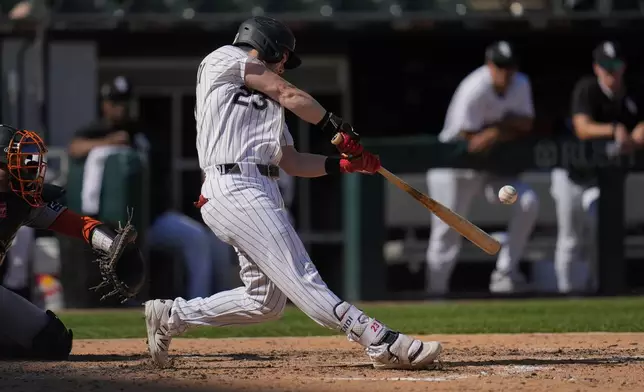 Chicago White Sox's Andrew Benintendi (23) hits a solo home run during the sixth inning of a baseball game against the San Francisco Giants, Saturday, June 28, 2025, in Chicago. (AP Photo/Erin Hooley)