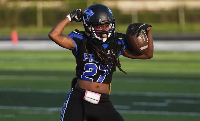 Detroit Prowl's Milana Stromile celebrates an interception against the Lansing Legacy during an AWFL women's football game in Allen Park, Mich., Saturday, May 10, 2025. (AP Photo/Paul Sancya)