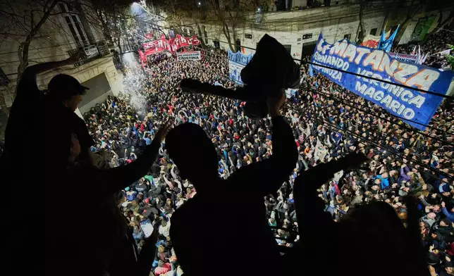 Supporters of former President Cristina Fernandez chant slogans in front of her home after Argentina's Supreme Court upheld her corruption conviction, in Buenos Aires, Argentina, Tuesday, June 10, 2025. (AP Photo/Rodrigo Abd)