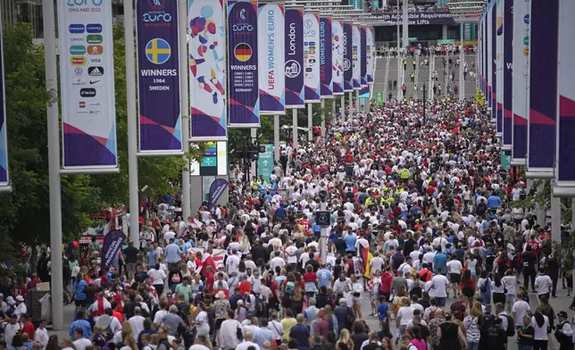 FILE - Supporters arrive for the final of the Women's Euro 2020 soccer match between England and Germany at Wembley stadium in London, Sunday, July 31, 2022. (AP Photo/Daniel Cole, file)