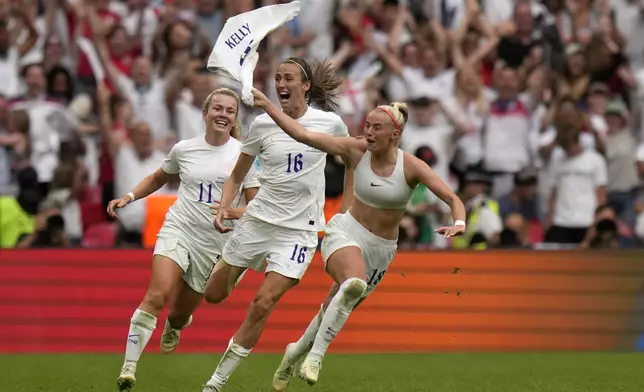 FILE - England's Chloe Kelly, right, celebrates after scoring her side's second goal during the Women's Euro 2022 final soccer match between England and Germany at Wembley stadium in London, Sunday, July 31, 2022. (AP Photo/Alessandra Tarantino, File)