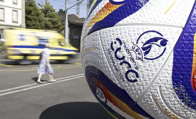 A giant soccer ball displayed in front of the Bern railway station plaza on the occasion of the Women's Euro 2025 soccer tournament, Wednesday, June 25, 2025, in Bern, Switzerland. (Anthony Anex/Keystone via AP)