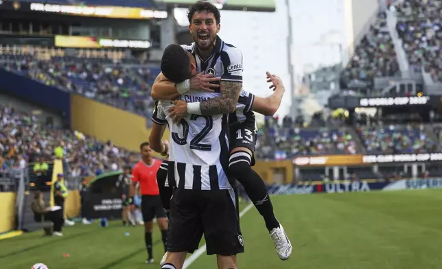 Botafogo's Jair Cunha celebrates after scoring the opening goal with Alex Telles, top, during the Club World Cup group B soccer match between Botafogo and Seattle Sounders at Seattle Lumen Field, in Seattle, Sunday, June 15, 2025.(AP Photo/Ryan Sun)