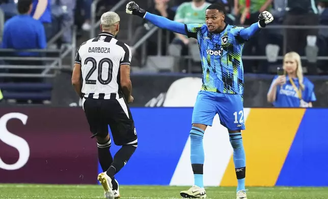 Botafogo's goalkeeper John, right, reacts with teammate Alexander Barboza during the Club World Cup group B soccer match between Botafogo and Seattle Sounders at Seattle Lumen Field, in Seattle, Sunday, June 15, 2025. (AP Photo/Lindsey Wasson)