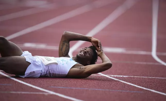 Chris Robinson, of the United States, reacts after falling past the finish line to win the men 400 meters hurdles during the Ostrava Golden Spike athletics meet in Ostrava, Czech Republic, Tuesday, June 24, 2025. (AP Photo/Petr David Josek)