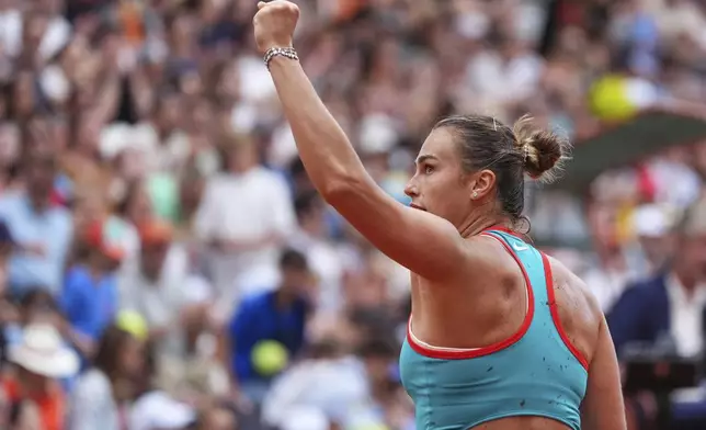 Aryna Sabalenka of Belarus celebrates beating Amanda Anisimova of the U.S. during their fourth round match of the French Tennis Open, at the Roland-Garros stadium, in Paris, Sunday, June 1 2025. (AP Photo/Lindsey Wasson)