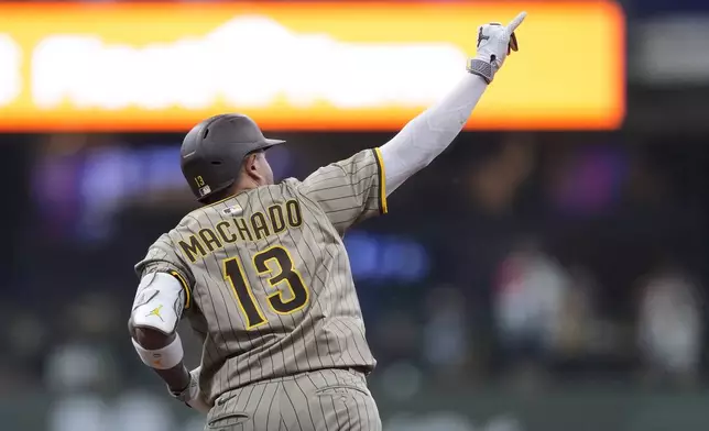 San Diego Padres' Manny Machado gestures as he rounds the bases after hitting a solo home run during the seventh inning of a baseball game against the Milwaukee Brewers, Sunday, June 8, 2025, in Milwaukee. (AP Photo/Aaron Gash)
