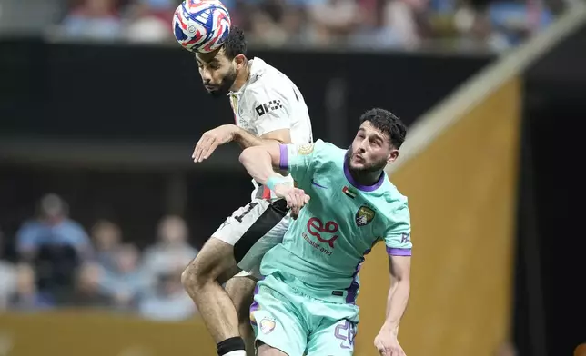 Manchester City's Rayan Ait-Nouri, top, heads a ball next to Al Ain's Nassim Chadli during the Club World Cup Group G soccer match between Manchester City and Al Ain in Atlanta, Sunday, June 22, 2025. (AP Photo/Brynn Anderson)