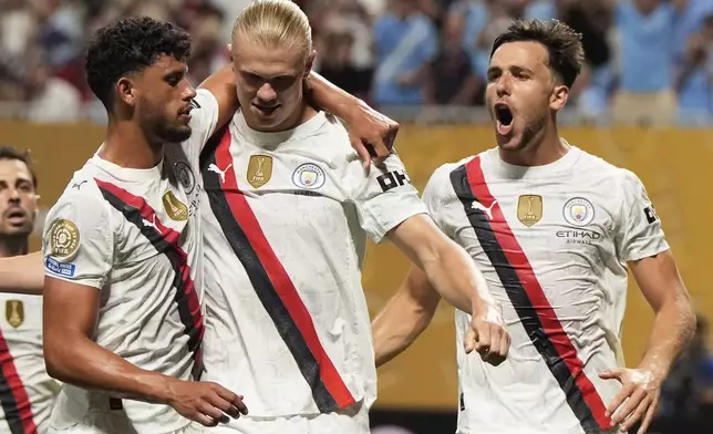 Manchester City's Erling Haaland, centre, is congratulated by teammates after scoring his team's third goal during the Club World Cup Group G soccer match between Manchester City and Al Ain in Atlanta, Sunday, June 22, 2025. (AP Photo/Mike Stewart)