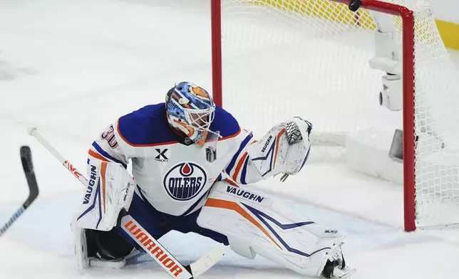 A Florida Panthers shot hits the crossbar behind Edmonton Oilers goalie Calvin Pickard during the first overtime period in Game 4 of the NHL hockey Stanley Cup Final in Sunrise, Fla., Thursday, June 12, 2025. (Nathan Denette/The Canadian Press via AP)