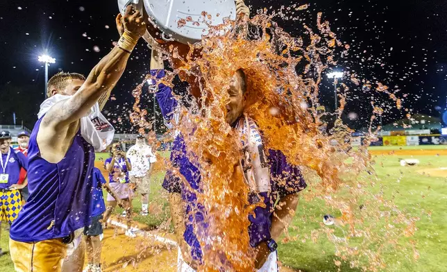 LSU Shreveport head coach Brad Neffendorf is doused by his players after defeating Southeastern of Florida to win the championship game of the NAIA World Series college baseball game, Friday, May 30 2025, at Harris Field in Lewiston, Idaho. (August Frank/Lewiston Tribune via AP)