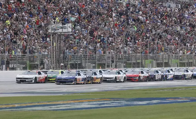 Driver Joey Logano (22) leads the field to the start of the race during a NASCAR Cup Series auto race, Saturday, June 28, 2025, in Hampton, Ga. (AP Photo/Butch Dill)