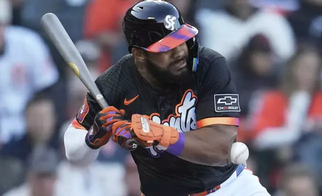 San Francisco Giants' Heliot Ramos is hit by a pitch from Cleveland Guardians pitcher Slade Cecconi during the first inning of a baseball game in San Francisco, Tuesday, June 17, 2025. (AP Photo/Jeff Chiu)