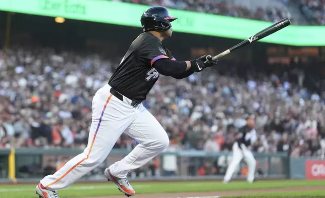 San Francisco Giants' Rafael Devers watches his RBI double during the third inning of a baseball game against the Cleveland Guardians in San Francisco, Tuesday, June 17, 2025. (AP Photo/Jeff Chiu)