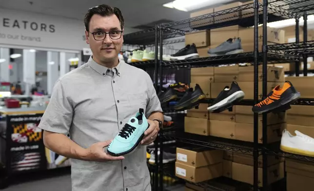 Alan Guyan, founder and CEO of Made Plus, holds a new colorway of the company's "bangr," a pickleball sneaker, at the company's manufacturing facility in Annapolis, Md., Tuesday, June 10, 2025. (AP Photo/Stephanie Scarbrough)
