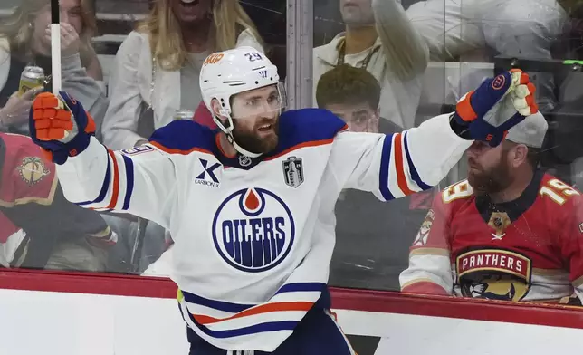 Edmonton Oilers' Leon Draisaitl (29) celebrates after his winning goal against the Florida Panthers during the first overtime period in Game 4 of the NHL hockey Stanley Cup Final in Sunrise, Fla., Thursday, June 12, 2025. (Nathan Denette/The Canadian Press via AP)