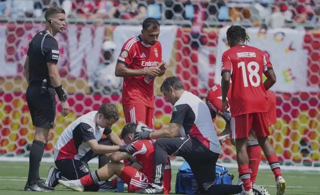 Benfica's Gianluca Prestianni is attended to during the Club World Cup Group C soccer match between Benfica and Bayern Munich in Charlotte, N.C., Tuesday, June 24, 2025. (AP Photo/Chris Carlson)