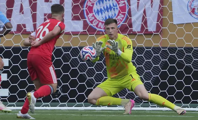 Benfica's Anatoliy Trubin blocks a shot during the Club World Cup Group C soccer match between Benfica and Bayern Munich in Charlotte, N.C., Tuesday, June 24, 2025. (AP Photo/Chris Carlson)