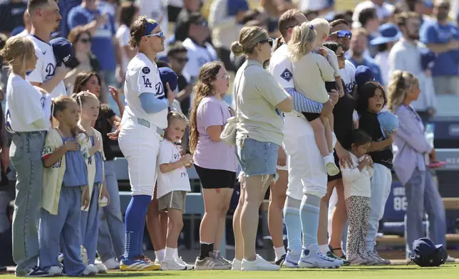 FILE - Los Angeles Dodgers' Enrique Hernández stands for the national anthem with his daughter before a baseball game against the San Francisco Giants in Los Angeles, Sunday, June 15, 2025. (AP Photo/Jessie Alcheh, File)