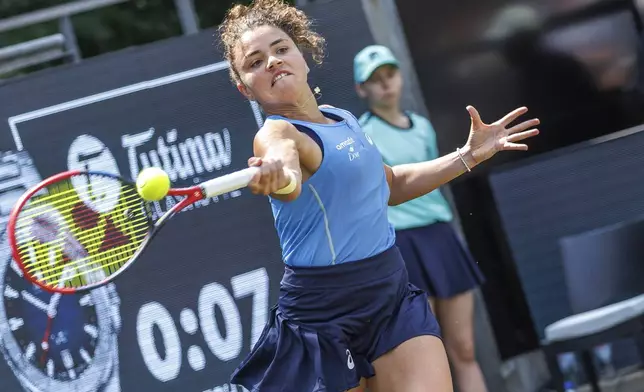 Italy's Jasmine Paolini returns the ball to Tunisia's Ons Jabeur during the Berlin WTA tennis tournament in Berlin, Germany, Wednesday, June 18, 2025. (Andreas Gora/dpa via AP)