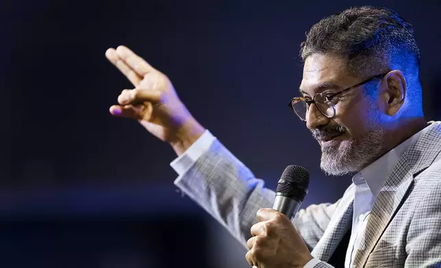 José Luis Orozco, a pastor from Nicaragua, ministers to members of the Oasis Church, in Taylor, Texas, June 15, 2025. (AP Photo/Rodolfo Gonzalez)