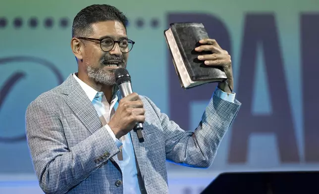 José Luis Orozco, a pastor from Nicaragua, ministers to members of the Oasis Church, in Taylor, Texas, on June 15, 2025. (AP Photo/Rodolfo Gonzalez)