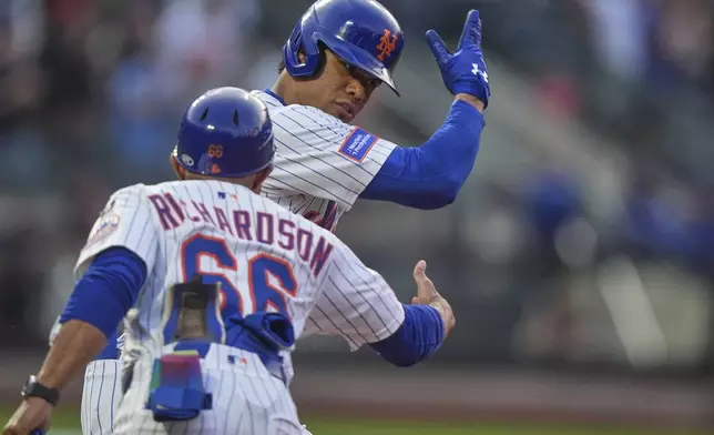 New York Mets' Juan Soto, right, celebrates with first base coach Antoan Richardson as he runs the bases after hitting a home run during the third inning of a baseball game against the Washington Nationals Tuesday, June 10, 2025, in New York. (AP Photo/Frank Franklin II)