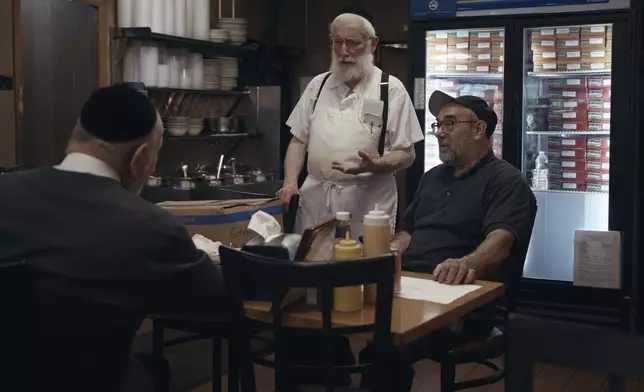 Hasidic Jewish men chat inside Gottlieb's Restaurant on Monday, June 16, 2025, in the Brooklyn borough of New York. (AP Photo/Andres Kudacki)