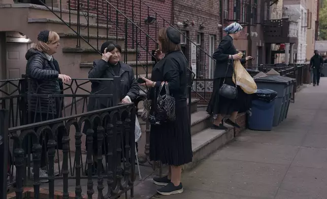 Hasidic Jewish women chat on Monday, June 16, 2025, in the Brooklyn borough of New York. (AP Photo/Andres Kudacki)