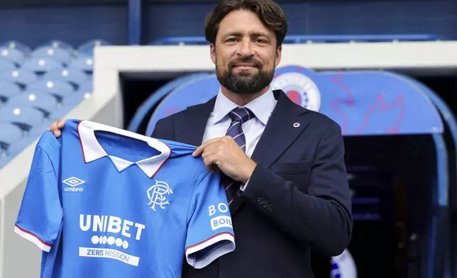 Rangers newly appointed head coach Russell Martin poses at the Ibrox Stadium after his presentation during a news conference, in Glasgow, Scotland, Thursday June 5, 2025. (Steve Welsh/PA via AP)