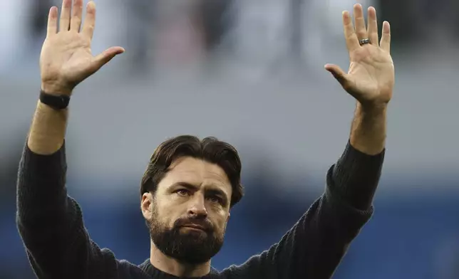 FILE - Southampton's head coach Russell Martin greets fans at the end of the English Premier League soccer match between Manchester City and Southampton at the Etihad Stadium in Manchester, England, Saturday, Oct. 26, 2024. (AP Photo/Darren Staples, File)