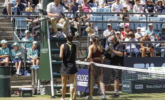 China's Xinyu Wang and Spain's Paula Badosa talk to the umpire as their women's singles quarter final tennis match was postponed due to injury, during the WTA Tour in Berlin, Friday, June 20, 2025. (Andreas Gora/dpa via AP)