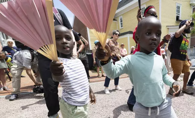 Levis Martin, left, and his brother Daniel dance during a Juneteenth celebration at the African Burying Ground Memorial Park Thursday, June 19, 2025, in Portsmouth, N.H. (AP Photo/Michael Dwyer)
