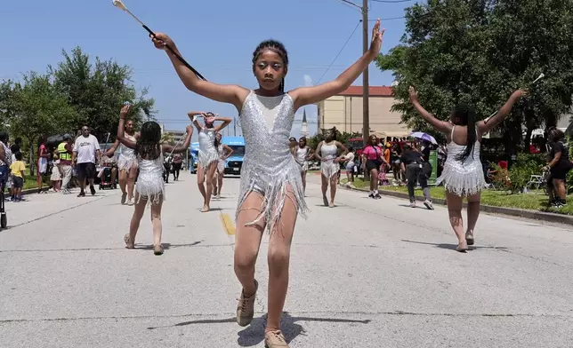 Kids participate in a Juneteenth parade Thursday, June 19, 2025, in Galveston, Texas. (AP Photo/David J. Phillip)
