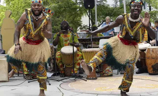 Members of the Akwaaba Ensemble Nii Osenda, left, and Samuel Marquaye dance during a Juneteenth celebration at the African Burying Ground Memorial Park Thursday, June 19, 2025, in Portsmouth, N.H. (AP Photo/Michael Dwyer)