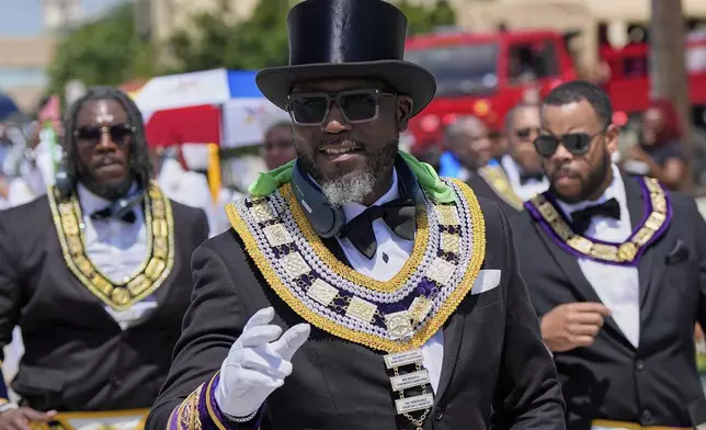 People participate during a Juneteenth parade Thursday, June 19, 2025, in Galveston, Texas. (AP Photo/David J. Phillip)