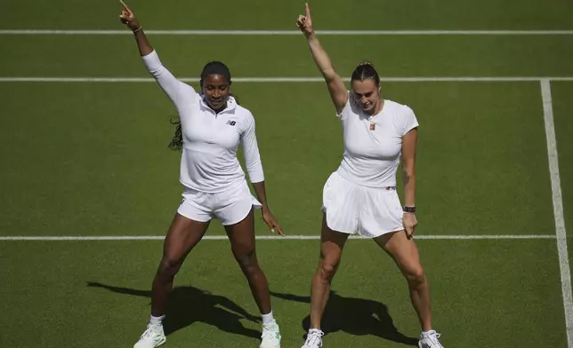 Aryna Sabalenka of Belarus, right, and Coco Gauff of United States dance during a practice session ahead of the Wimbledon Championships in London, Friday, June 27, 2025. (AP Photo/Kin Cheung)
