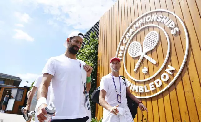 Novak Djokovic arrives at the practice courts at the All England Lawn Tennis and Croquet Club in Wimbledon ahead of the Wimbledon Championships, Friday June 27, 2025. (John Walton/PA via AP)