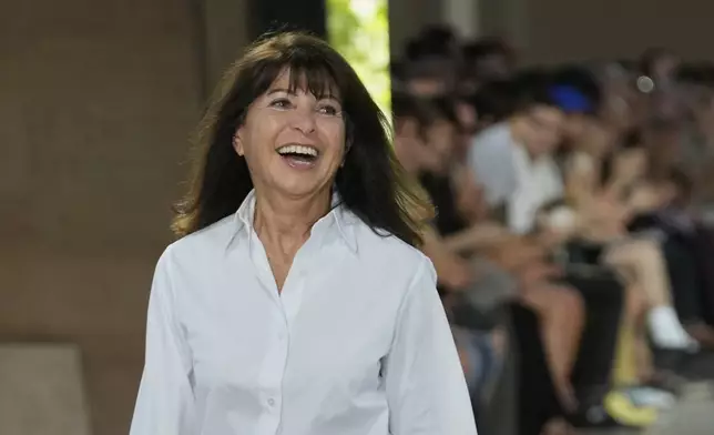 Fashion designer Veronique Nichanian acknowledges applause after the presentationof the men's Hermes Spring-Summer 2026 collection, that was presented in Paris Saturday, June 28, 2025. (AP Photo/Michel Euler)