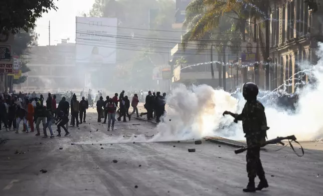 Riot police uses tear gas Thursday June 12, 2025 to disperse demonstrators during a protest over the death of blogger Albert Ojwang in police custody Nairobi, Kenya. (AP Photo/Andrew Kasuku)