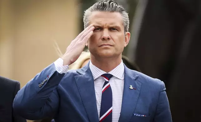 U.S. Defense Secretary Pete Hegseth salutes during a ceremony at the US cemetery to commemorate the 81st anniversary of the D-Day landings, Friday, June 6, 2025 in Colleville-sur-Mer, Normandy. (AP Photo/Thomas Padilla)